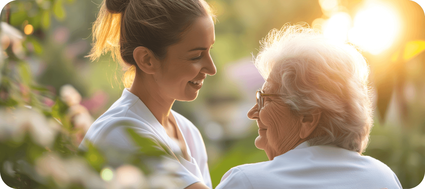 Caregiver and resident in a warm, natural setting—quality care in action
